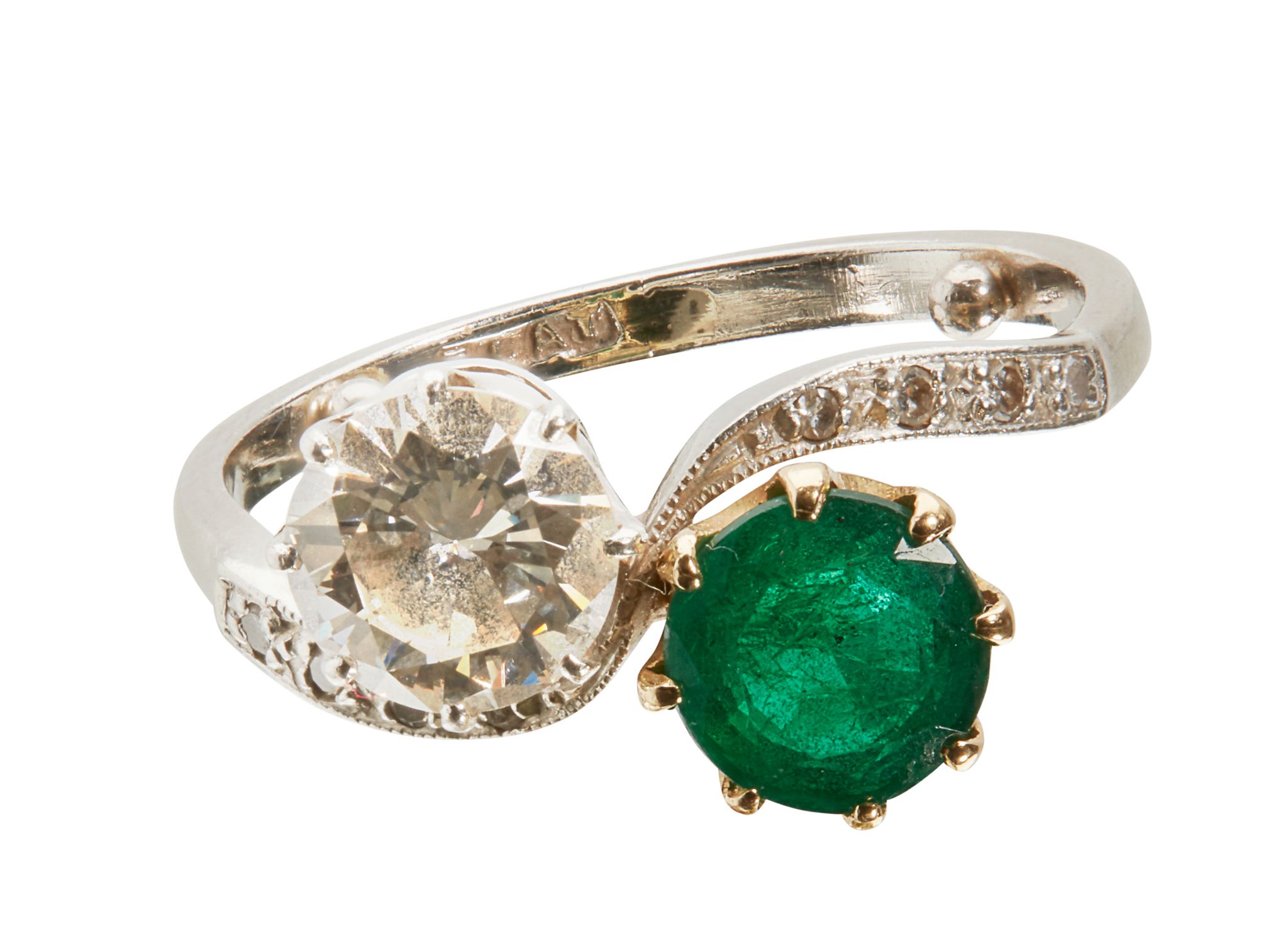 A DIAMOND AND EMERALD SET TWIST RING | Sold for £1,375*